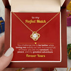 Gold necklace in a gift box with a romantic message, held by a hand.